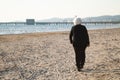 Puntone Scarlino, Maremma Tuscany, Italy. Senior woman walking on the beach Royalty Free Stock Photo