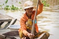 Local Cambodian woman rowing along Tonle Sap lake, Puok, Siem Reap Province, Cambodia Royalty Free Stock Photo