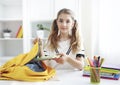 Pupil child put books and notes into backpack. School supplies.Back to school concept. Girl prepare staff for education. Kid Royalty Free Stock Photo