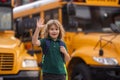 Pupil getting on the school bus. American School. Back to school. Kid of primary school. Happy children ready to study. Royalty Free Stock Photo