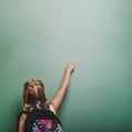 Pupil girl writing blackboard. High quality and resolution beautiful photo concept Royalty Free Stock Photo