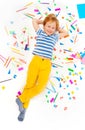 Pupil having rest laying among heap of stationery Royalty Free Stock Photo