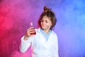 Pupil holding conical flask in smoke against blackboard with chemistry formulas Royalty Free Stock Photo