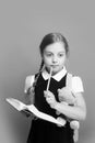 Pupil holds blue book, marker and teddy bear. Kid in school uniform. Pupil holds book and teddy bear Royalty Free Stock Photo