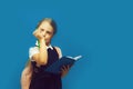 Pupil holds book and green marker. Back to school concept Royalty Free Stock Photo