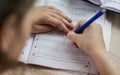 A pupil learns at home to write distance learning for children Royalty Free Stock Photo