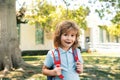 Pupil of primary school with book in hand. Schoolboy with backpack near school outdoors. Beginning of lessons. Royalty Free Stock Photo