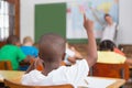 Pupil raising hand in classroom