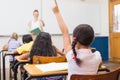 Pupil raising hand in classroom Royalty Free Stock Photo