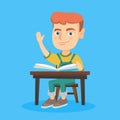 Pupil raising hand while sitting at the desk. Royalty Free Stock Photo