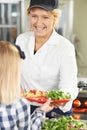 Pupil In School Cafeteria Being Served Lunch By Dinner Lady Royalty Free Stock Photo