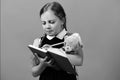 Pupil in school uniform with braids. Girl holds teddy bear Royalty Free Stock Photo