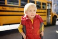 Pupil with schoolbag with yellow school bus on background Royalty Free Stock Photo