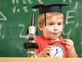 Pupil waiting for school break. Child on excited face looks at alarm clock. School break concept. Kid boy in academic