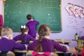 Pupil works with the board in the classroom