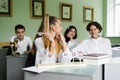 Pupils at biology lesson at school with animal cell models on the table. Biology teacher gives a lesson to Royalty Free Stock Photo