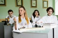 Pupils at biology lesson at school with animal cell models on the table. Biology teacher gives a lesson to Royalty Free Stock Photo