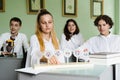 Pupils at biology lesson at school with animal cell models on the table. Biology teacher gives a lesson to Royalty Free Stock Photo