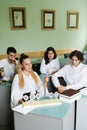 Pupils at biology lesson at school with animal cell models on the table. Biology teacher gives a lesson to Royalty Free Stock Photo