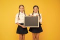 Pupils community. School schedule. School girls cute pupils hold blackboard copy space. School announcement concept