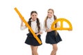 Pupils cute girls with big rulers. Favorite school subject. Education and school concept. School students learning