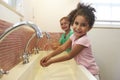 Pupils At Montessori School Washing Hands In Washroom