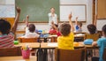 Pupils raising their hands during class