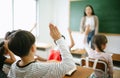 Pupils raising their hands during class at the elementary school, closeup. Education, learning and people concept Royalty Free Stock Photo