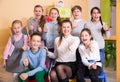 Pupils with teacher giving thumbs up in schoolroom Royalty Free Stock Photo