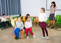 Pupils with teacher playing musical chairs