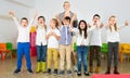 Pupils with teacher posing, giving thumbs up Royalty Free Stock Photo