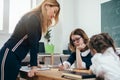 Pupils and teacher reading book in classroom Royalty Free Stock Photo