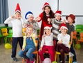 Pupils with teacher in Santa hats giving thumbs up Royalty Free Stock Photo