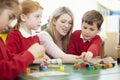 Pupils And Teacher Working With Coloured Blocks Royalty Free Stock Photo