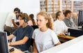 Pupils using computers at lesson, teacher teaching them in class room Royalty Free Stock Photo