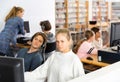 Pupils using computers at lesson, teacher teaching them in class room Royalty Free Stock Photo