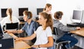 Pupils using computers at lesson, teacher teaching them in class room Royalty Free Stock Photo