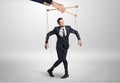 Puppet businessman leaded by a huge hand Royalty Free Stock Photo