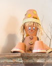 Puppet made of flowerpots and straw sitting on a board Royalty Free Stock Photo