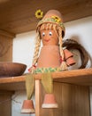 Puppet made of flowerpots and straw sitting on a board Royalty Free Stock Photo