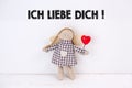 Puppet with a red heart and a `Ich liebe dich!` text: Translation: `I love you`