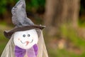 Puppet in wood and purple fabric with pumpkin-shaped face for halloween holidays, seen in detail