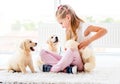 Puppies play with cheerful girl
