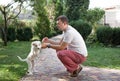 Puppy, a cute white labrador puppy next to a sitting man