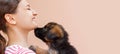 Puppy is giving a kiss to its girl owner Royalty Free Stock Photo