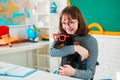 Puppy in glasses with funni student girl in glasses. Funny pupil looking for a drawing concept. Friendly teenager girl