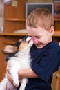 Puppy licking childs face Royalty Free Stock Photo