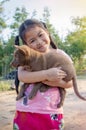 Puppy in a love hug of smiling Asia girl Royalty Free Stock Photo