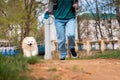 Puppy school. Girl running with her white fluffy cute Pomeranian in a park. Training of domestic purebred dogs Royalty Free Stock Photo