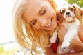 Puppys day out. a smiling, beautiful blonde holding her puppy while enjoying a day out. Royalty Free Stock Photo